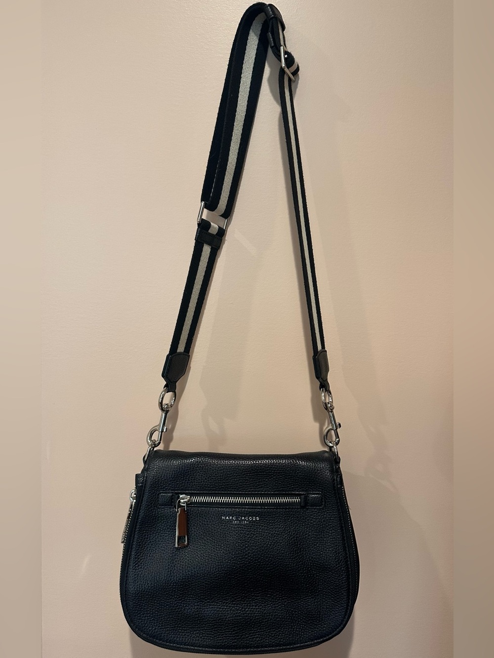 Marc Jacob’s black peopled leather Gotham crossbody saddle bag.